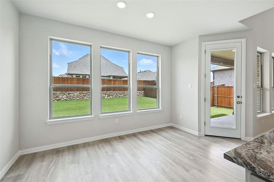 Unfurnished dining area with plenty of natural light, light wood-type flooring, and recessed lighting Unfurnished dining area with plenty of natural light, light wood-type flooring, and recessed lighting