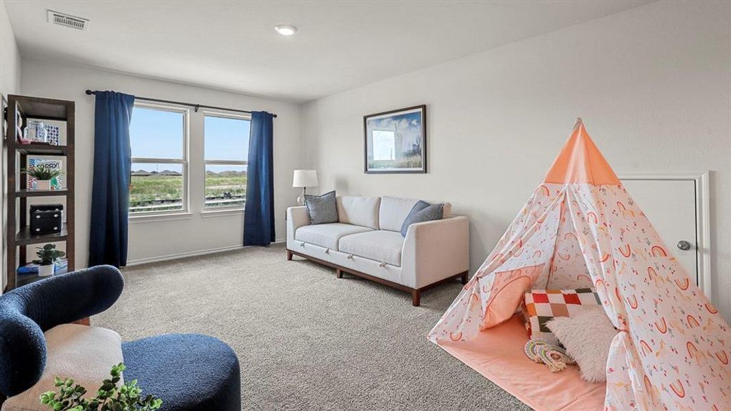 Carpeted living area featuring baseboards