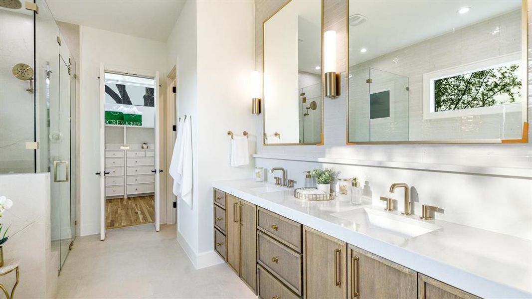 Bathroom featuring an enclosed shower, dual bowl vanity, and hardwood / wood-style floors