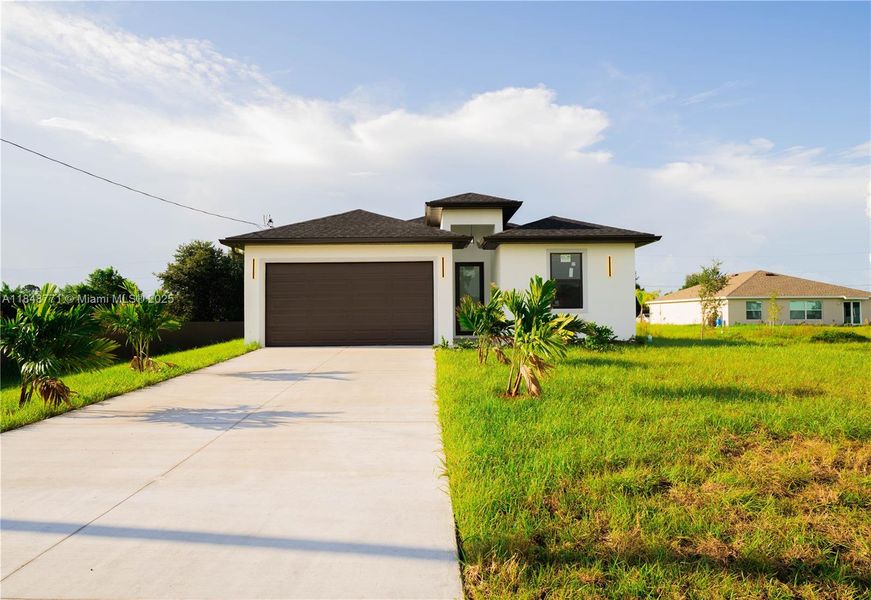 Front exterior of a new home in , Lehigh Acres, FL, highlighting curb appeal (Image 14). Front exterior of a new home in , Lehigh Acres, FL, highlighting curb appeal (Image 14).
