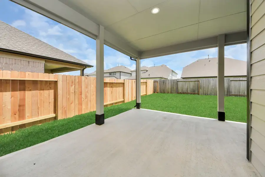 Experience outdoor living at its finest on this expansive covered patio, thoughtfully designed for BBQs and delightful outdoor dining. Sample photo of completed home with similar floor plan. Actual colors and selections may vary. Experience outdoor living at its finest on this expansive covered patio, thoughtfully designed for BBQs and delightful outdoor dining. Sample photo of completed home with similar floor plan. Actual colors and selections may vary.