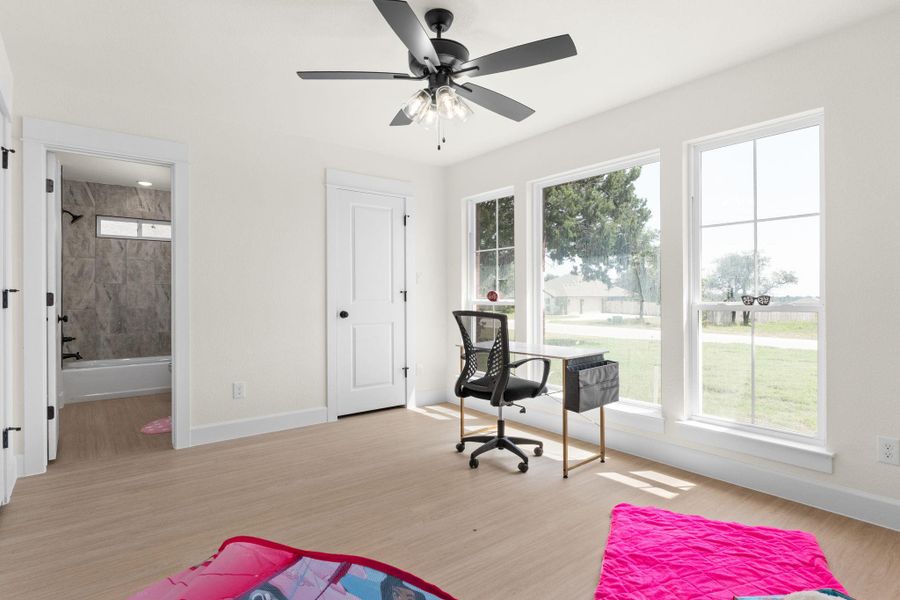 Office area featuring light wood-style floors and a ceiling fan