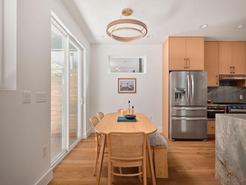 Dining area with light wood-style floors and recessed lighting Dining area with light wood-style floors and recessed lighting