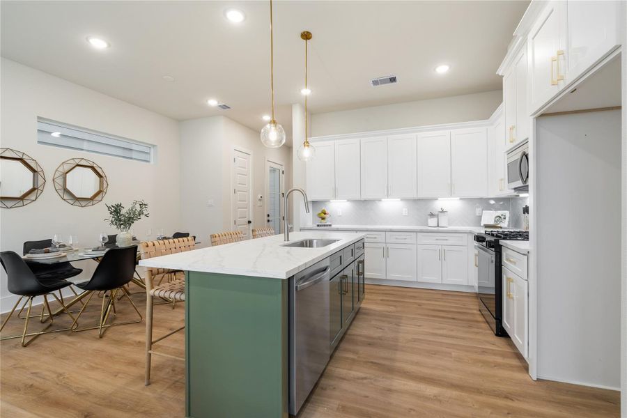 Whether it’s casual mornings or hosting friends, the oversized island creates a natural place to gather, blending function with a space that feels warm and inviting. Whether it’s casual mornings or hosting friends, the oversized island creates a natural place to gather, blending function with a space that feels warm and inviting.