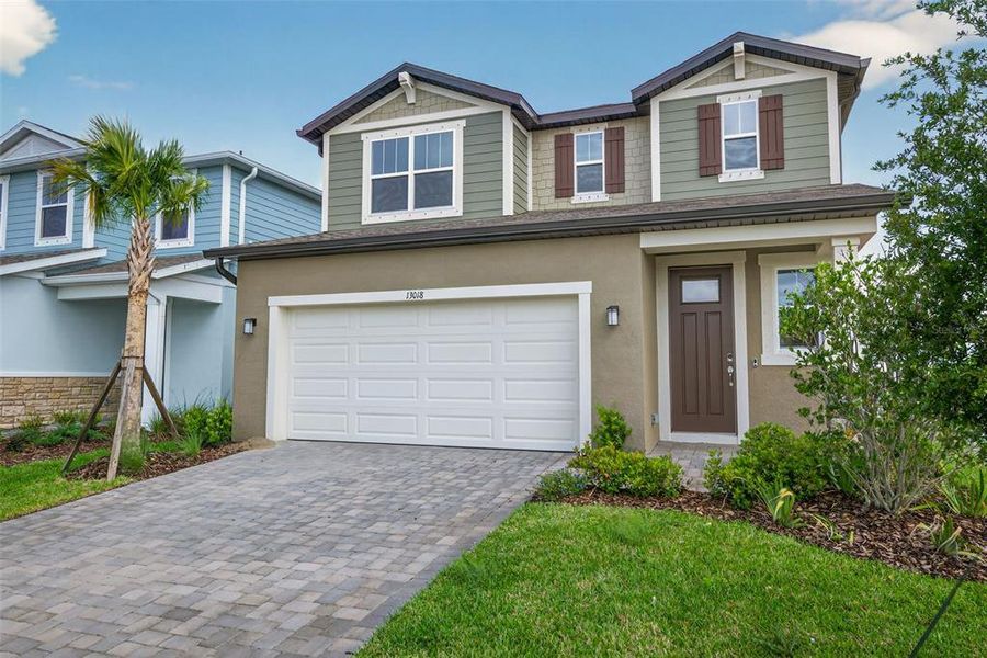 Front exterior of a new home in Crosswind Ranch, Parrish, FL, highlighting curb appeal (Image 2). Front exterior of a new home in Crosswind Ranch, Parrish, FL, highlighting curb appeal (Image 2).