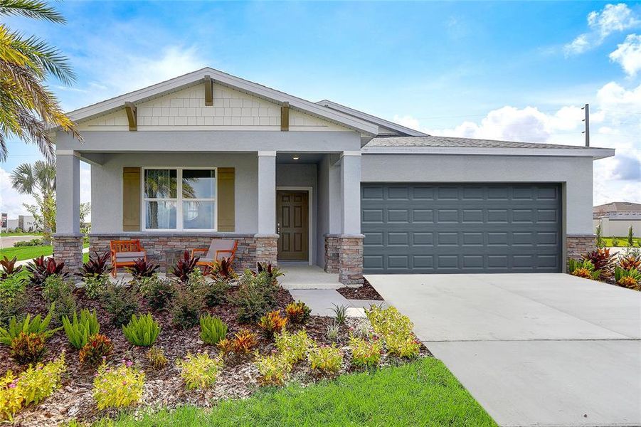 Front exterior of a new home in Sunset Lakes Estates, Mascotte, FL, highlighting curb appeal (Image 1).