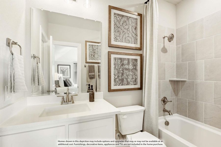 Bathroom with white vanity, large mirror, and tiled shower-tub combo with curtain