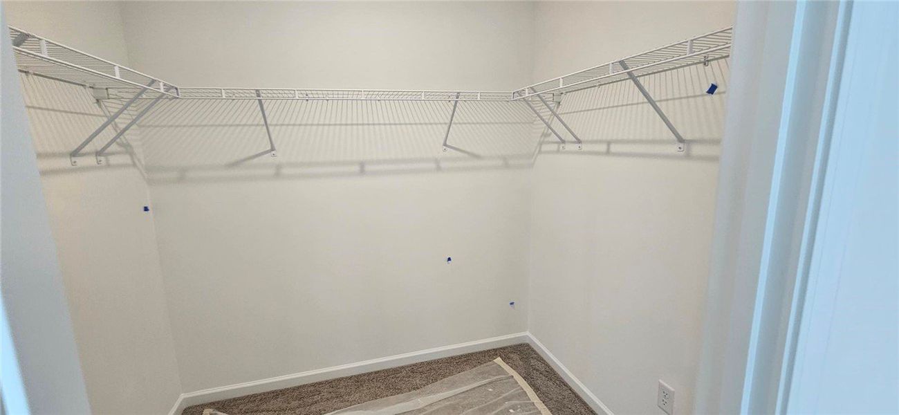 This spacious walk-in closet offers abundant stora
