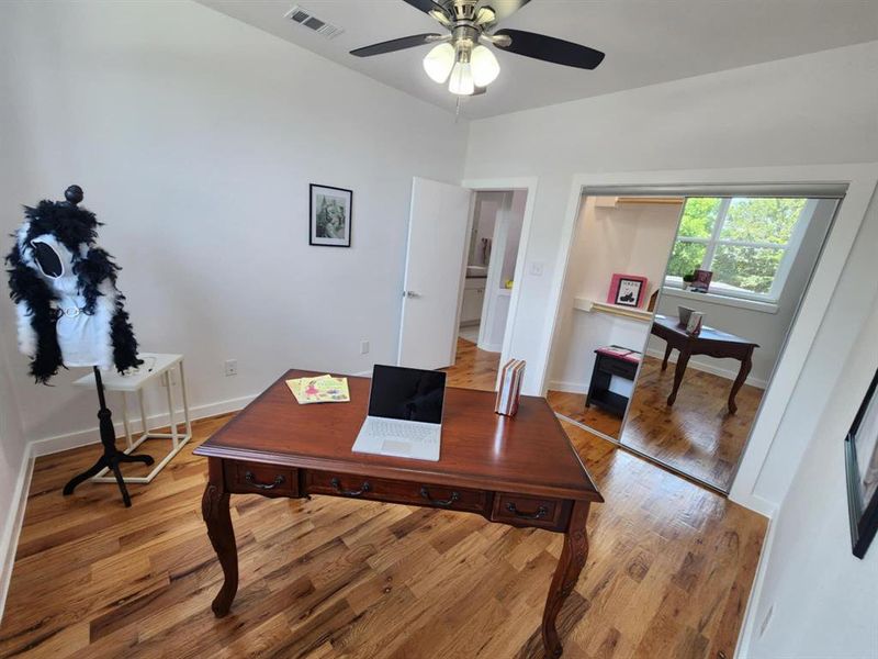 Office area with ceiling fan and wood-type flooring