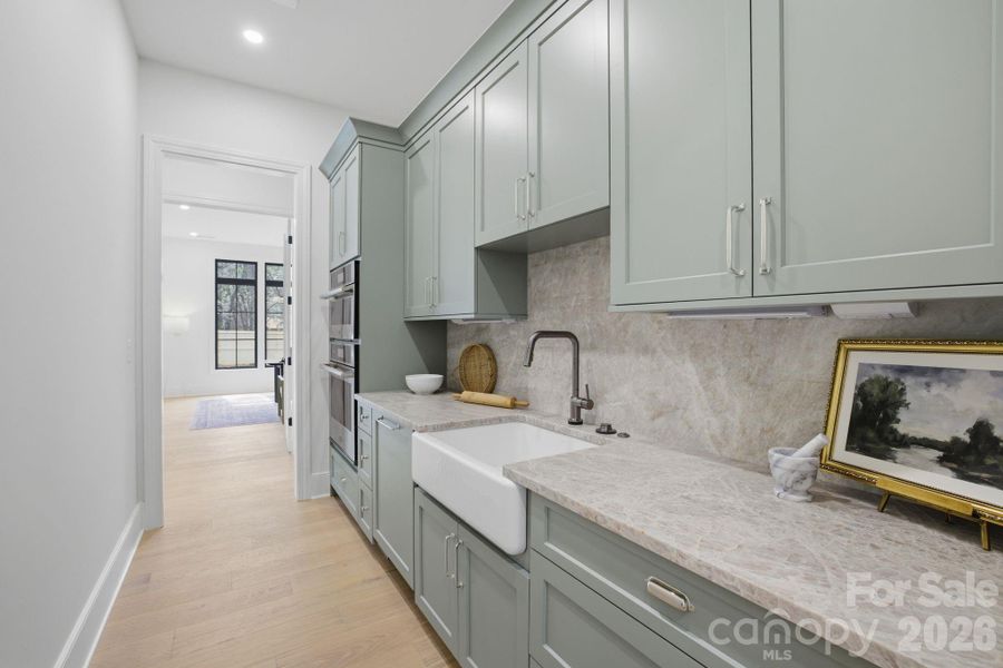 A Separate working pantry is behind the range wall-mages represent a previously completed home by the builder showcasing a similar design and layout. Photos are intended to reflect overall design intent and craftsmanship; actual selections, materials, finishes, and features for this home may differ
