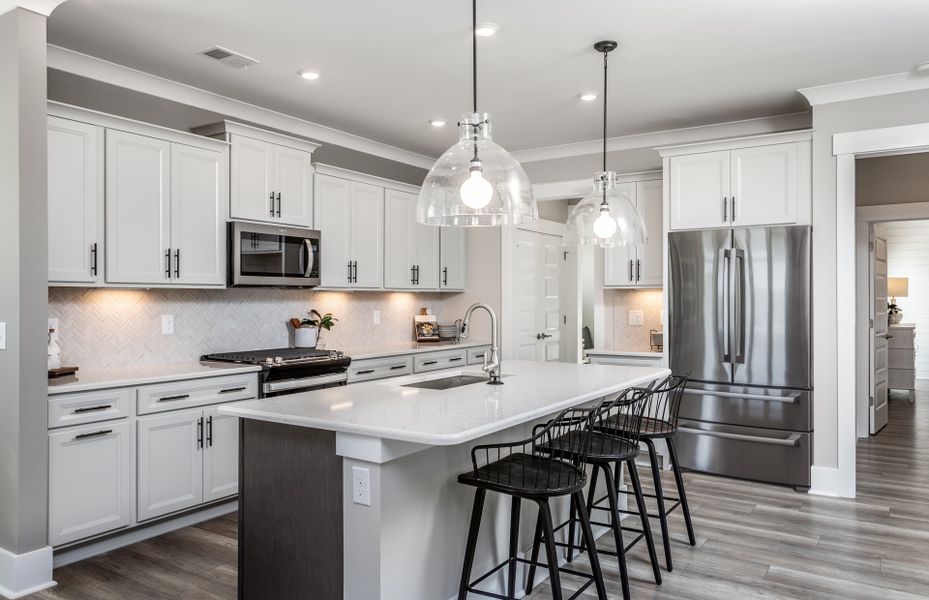 Kitchen Area with Large Kitchen Island for seating. Model Home Representation.