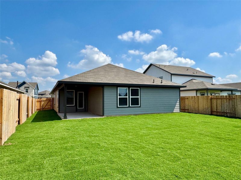 Back of house with a patio area, a fenced backyard, and roof with shingles
