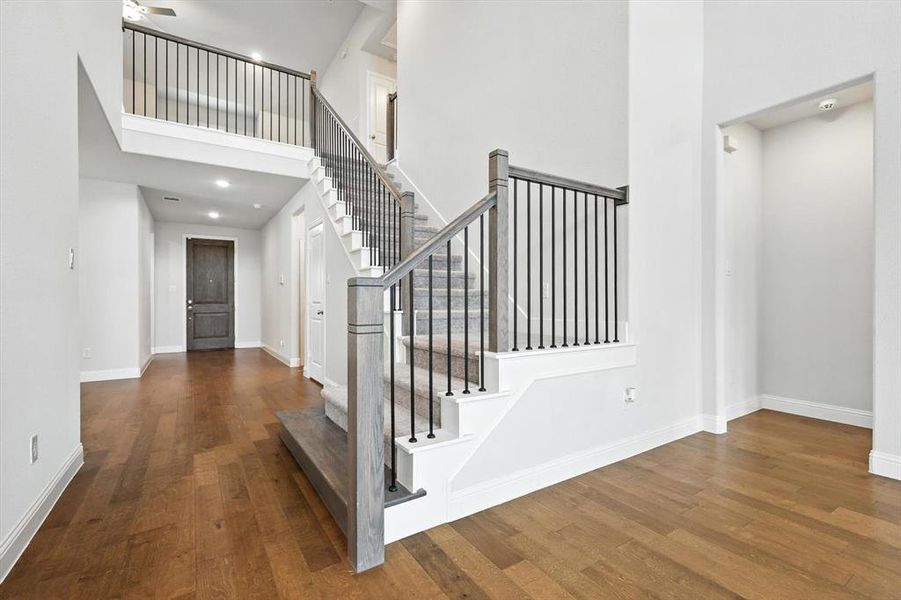 Open Staircase showcasing the heigh of the ceilings and allowing for substantial natural light!