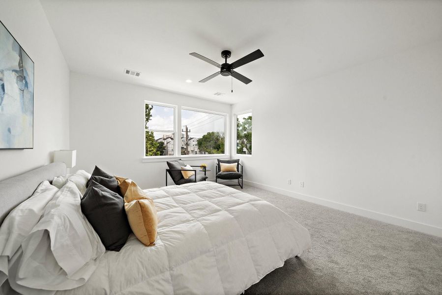 The generously sized primary bedroom offers an abundance of natural light, creating a bright and welcoming retreat.