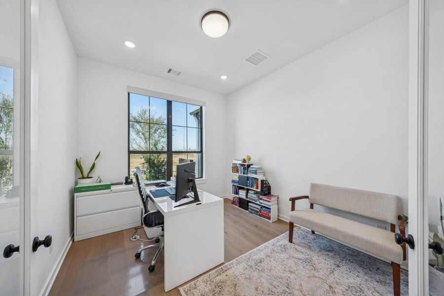 The home office is large and privately placed at the front of the home, away from the living area.