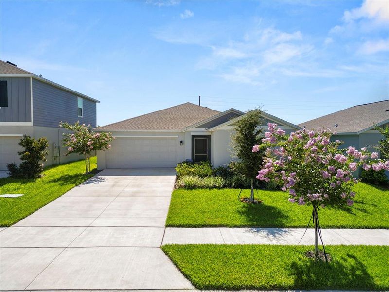 Front exterior of a new home in Hunt Club Groves, Lake Wales, FL, highlighting curb appeal (Image 22).