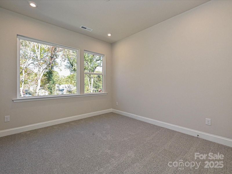 Secondary Bedroom With Large Windows Facing Mature Trees. Secondary Bedroom With Large Windows Facing Mature Trees.
