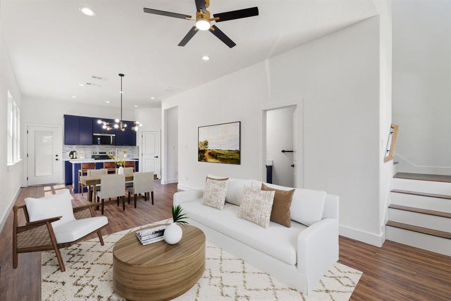 Living area with dark wood finished floors, recessed lighting, stairs, and ceiling fan