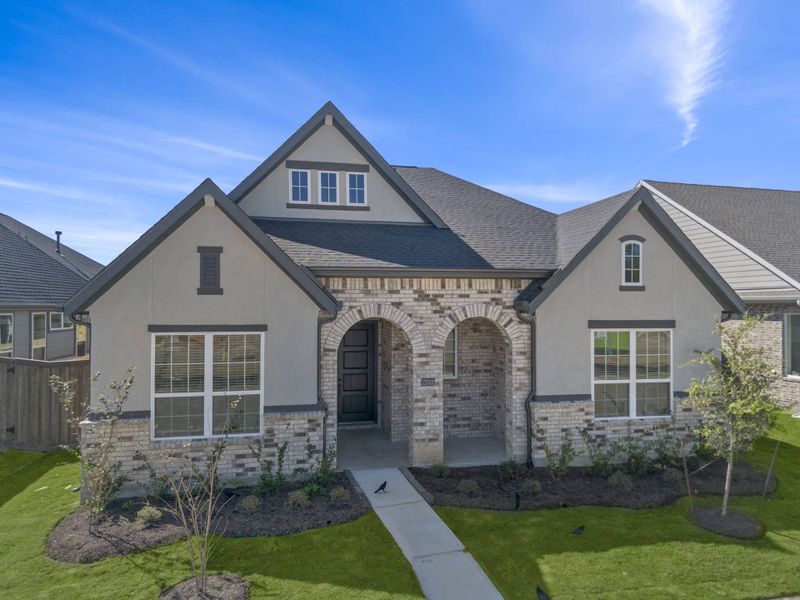 Front exterior of a new home in Riceland, Mont Belvieu, TX, highlighting curb appeal (Image 28). Front exterior of a new home in Riceland, Mont Belvieu, TX, highlighting curb appeal (Image 28).
