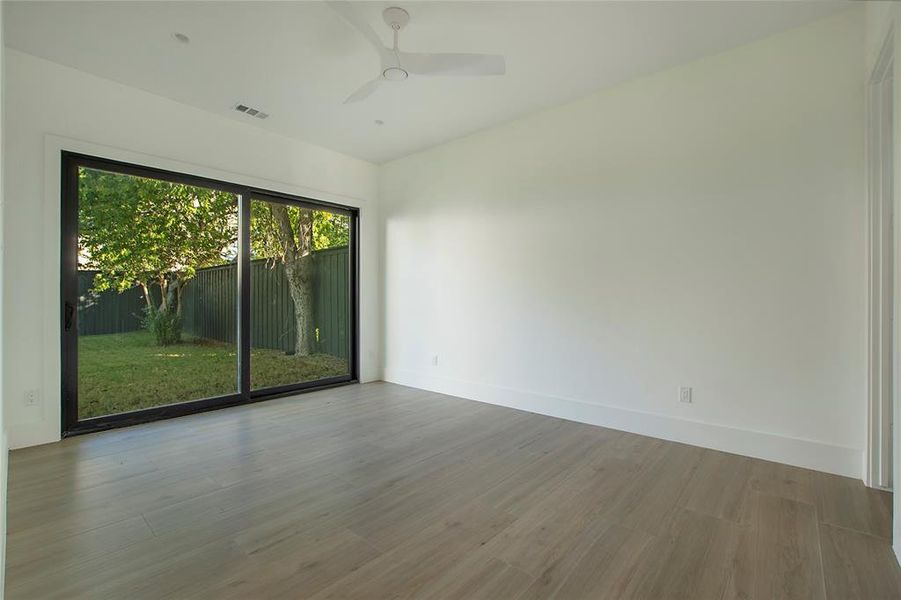 Unfurnished room featuring ceiling fan and light wood-type flooring