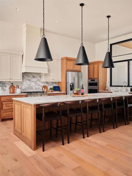 An inviting kitchen island anchors this culinary space, offering both preparation area and casual dining. An inviting kitchen island anchors this culinary space, offering both preparation area and casual dining.