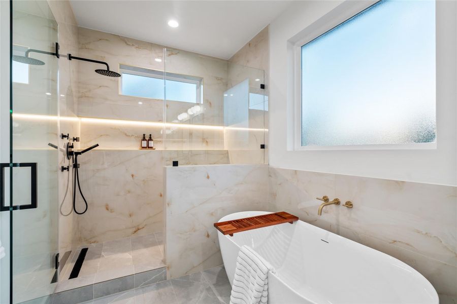 The primary bathroom is a true spa retreat, featuring a luxurious freestanding soaking tub and an expansive walk-in shower designed for both relaxation and functionality. The primary bathroom is a true spa retreat, featuring a luxurious freestanding soaking tub and an expansive walk-in shower designed for both relaxation and functionality.