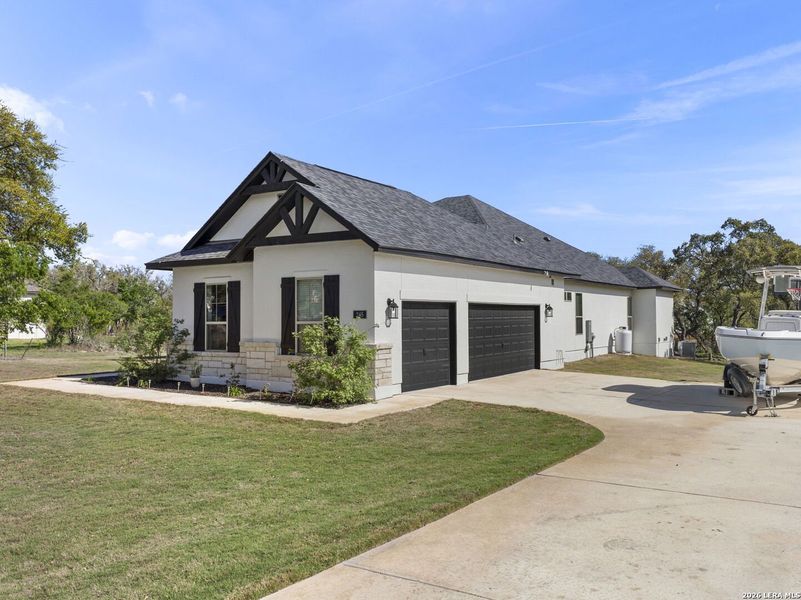 Front exterior of a new home in Potranco Acres, Castroville, TX, highlighting curb appeal (Image 22).