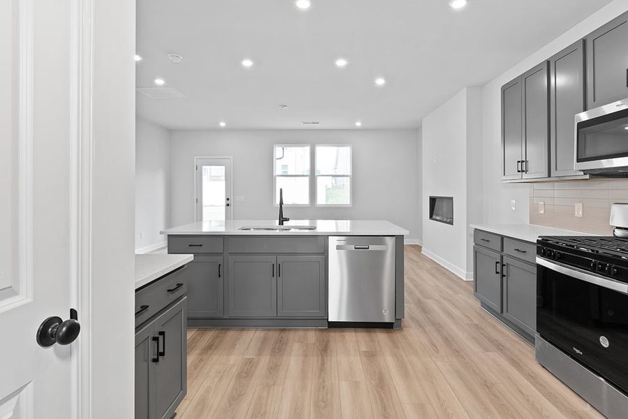 A kitchen with black cabinets. A kitchen with black cabinets.