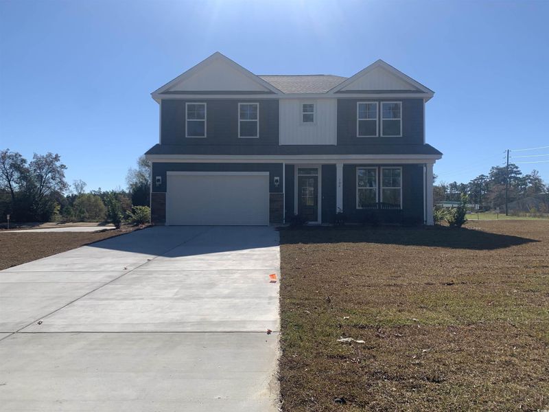 View of front facade with a garage and concrete driveway