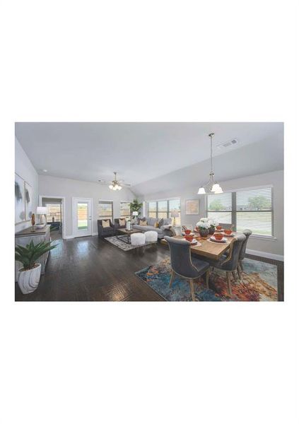 Dining space featuring ceiling fan, vaulted ceiling, and hardwood / wood-style flooring