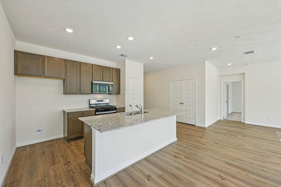 This spacious kitchen has it all—ample storage, generous counter space, and a layout that truly makes it the heart of the home.