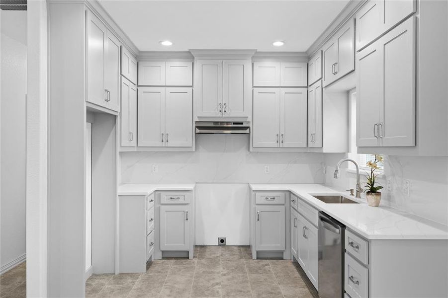 Kitchen with stainless steel dishwasher, backsplash, light stone countertops, recessed lighting, and under cabinet range hood Kitchen with stainless steel dishwasher, backsplash, light stone countertops, recessed lighting, and under cabinet range hood
