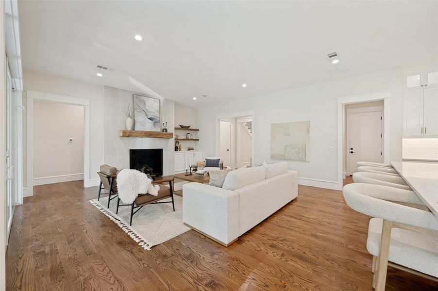 Open-concept living space with wood-finish flooring