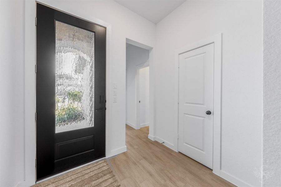 A light-filled entryway welcomes guests with clean lines and warm tile flooring. A light-filled entryway welcomes guests with clean lines and warm tile flooring.