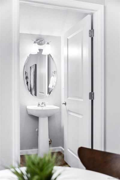 A view of the powder room with pedestal sink