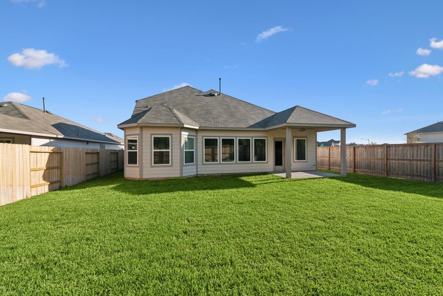 Exterior details and patio area of a home in Pinewood at Grand Texas, New Caney (Image 2).