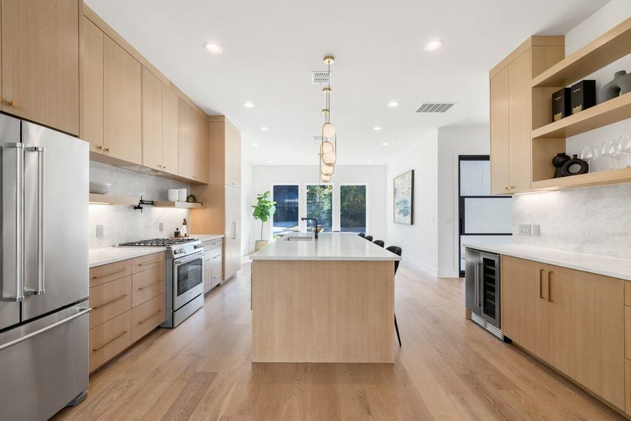 Kitchen with open shelves, light brown cabinetry, tasteful backsplash, and recessed lighting Kitchen with open shelves, light brown cabinetry, tasteful backsplash, and recessed lighting