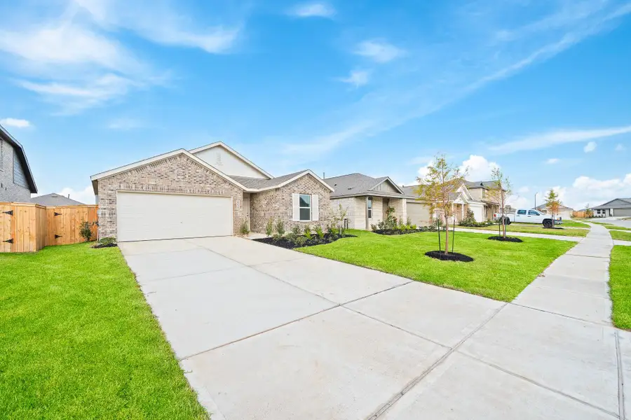 Front exterior of a new home in The Grand Prairie, Hockley, TX, highlighting curb appeal (Image 18). Front exterior of a new home in The Grand Prairie, Hockley, TX, highlighting curb appeal (Image 18).