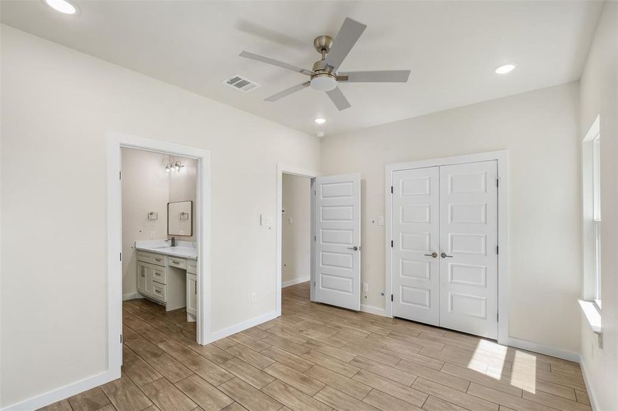 Bedroom featuring wood-look tile flooring, recessed lighting, and a ceiling fan Bedroom featuring wood-look tile flooring, recessed lighting, and a ceiling fan