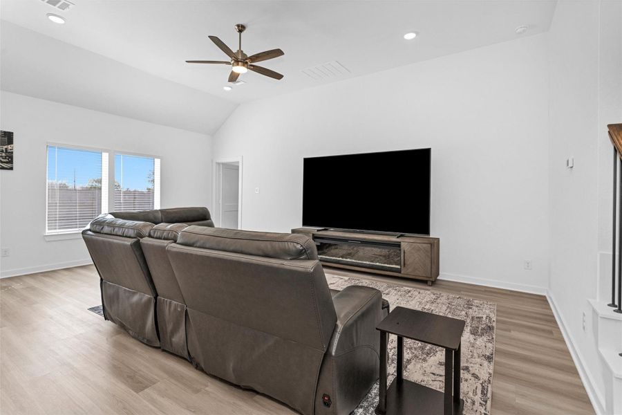 This comfortable family room features and a generous media wall—creating an ideal space for relaxing, entertaining, and movie nights.