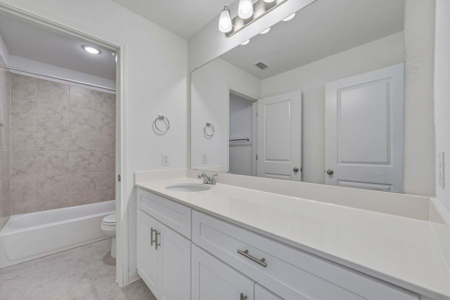 Full bath featuring vanity and shower / tub combination