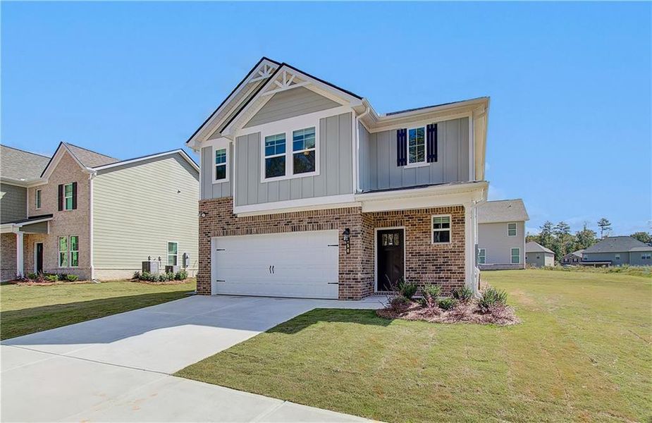 Front exterior of a new home in Enclave at Evergreen, Fairburn, GA, highlighting curb appeal (Image 2). Front exterior of a new home in Enclave at Evergreen, Fairburn, GA, highlighting curb appeal (Image 2).