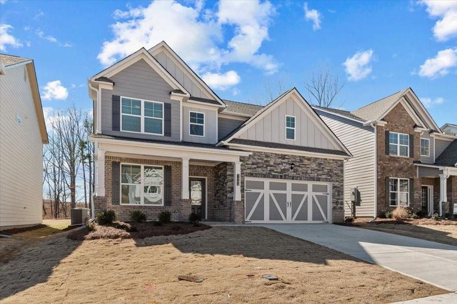 Front exterior of a new home in Clark Farms, Flowery Branch, GA, highlighting curb appeal (Image 2). Front exterior of a new home in Clark Farms, Flowery Branch, GA, highlighting curb appeal (Image 2).