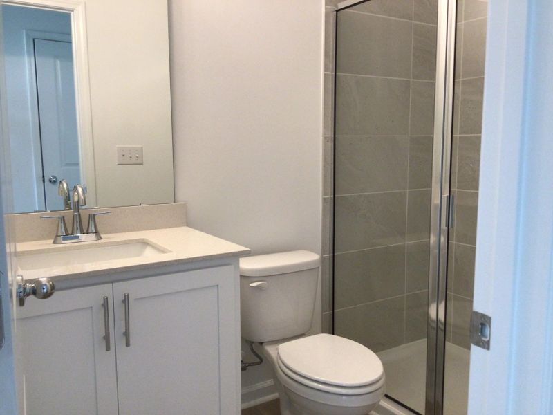 Guest Bath featuring the AW Collection® Coastal - Bright with white cabinets and quartz countertops.