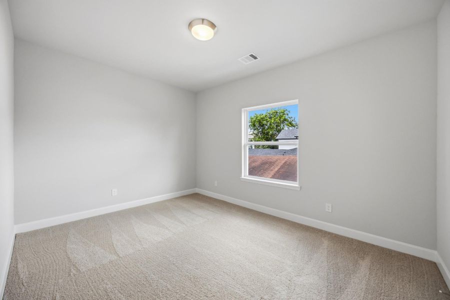 The first of two secondary bedrooms is the perfect spot for a guest room, home office, or nursery.
