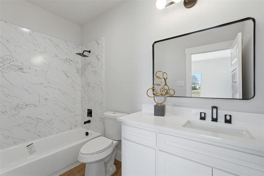Full bathroom featuring bathtub / shower combination, vanity, and dark wood finished floors