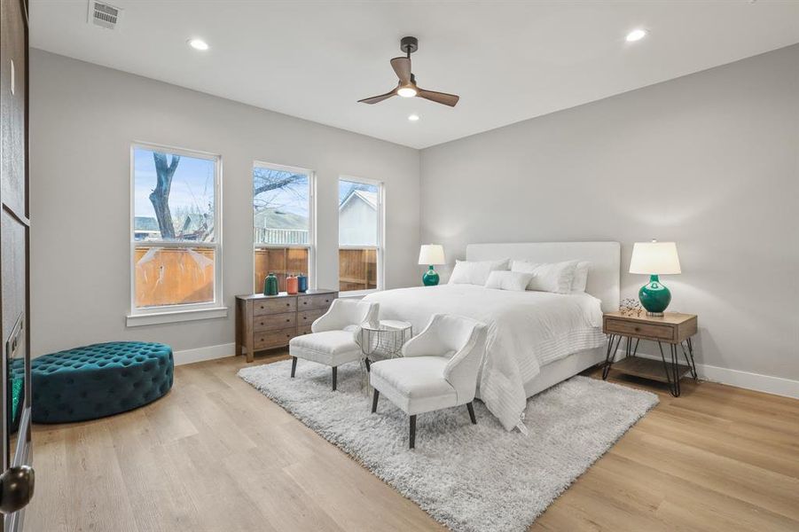 Bedroom with light hardwood / wood-style floors and ceiling fan