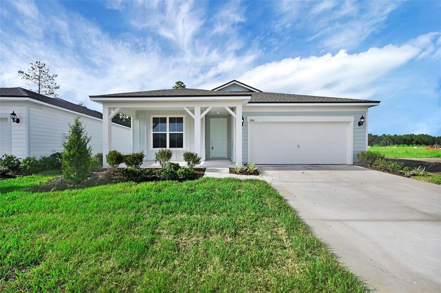 Front exterior of a new home in Seminole Palms, Palm Coast, FL, highlighting curb appeal (Image 20).