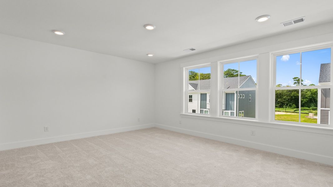 Relax in the Brookgreen primary suite at Seabreeze—serene style and comfort in every detail.