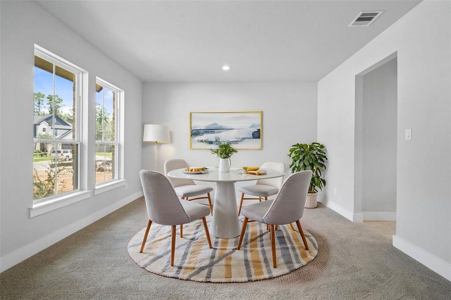 Make memories gathered around the table with your family and friends! This dining room features high ceilings, custom paint, plush carpet flooring, recessed lighting, and large windows with privacy blinds.